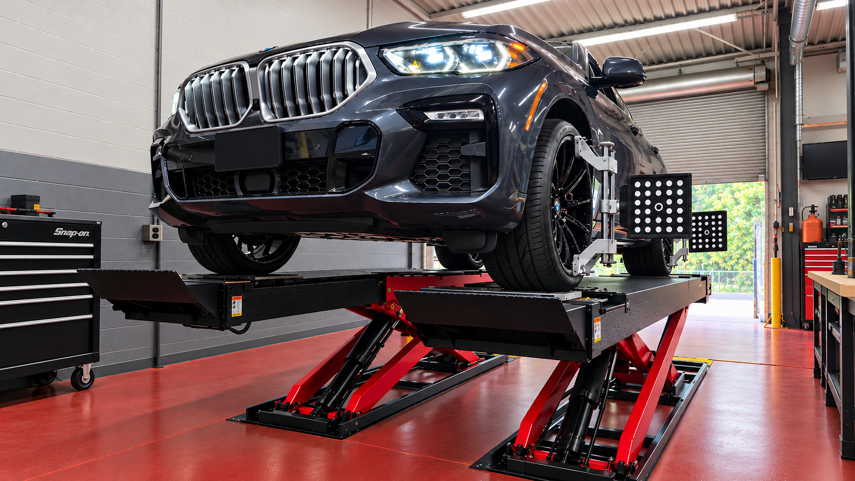 A car raised on the alignment rack at Level Auto with 3D imaging targets clamped to its wheels